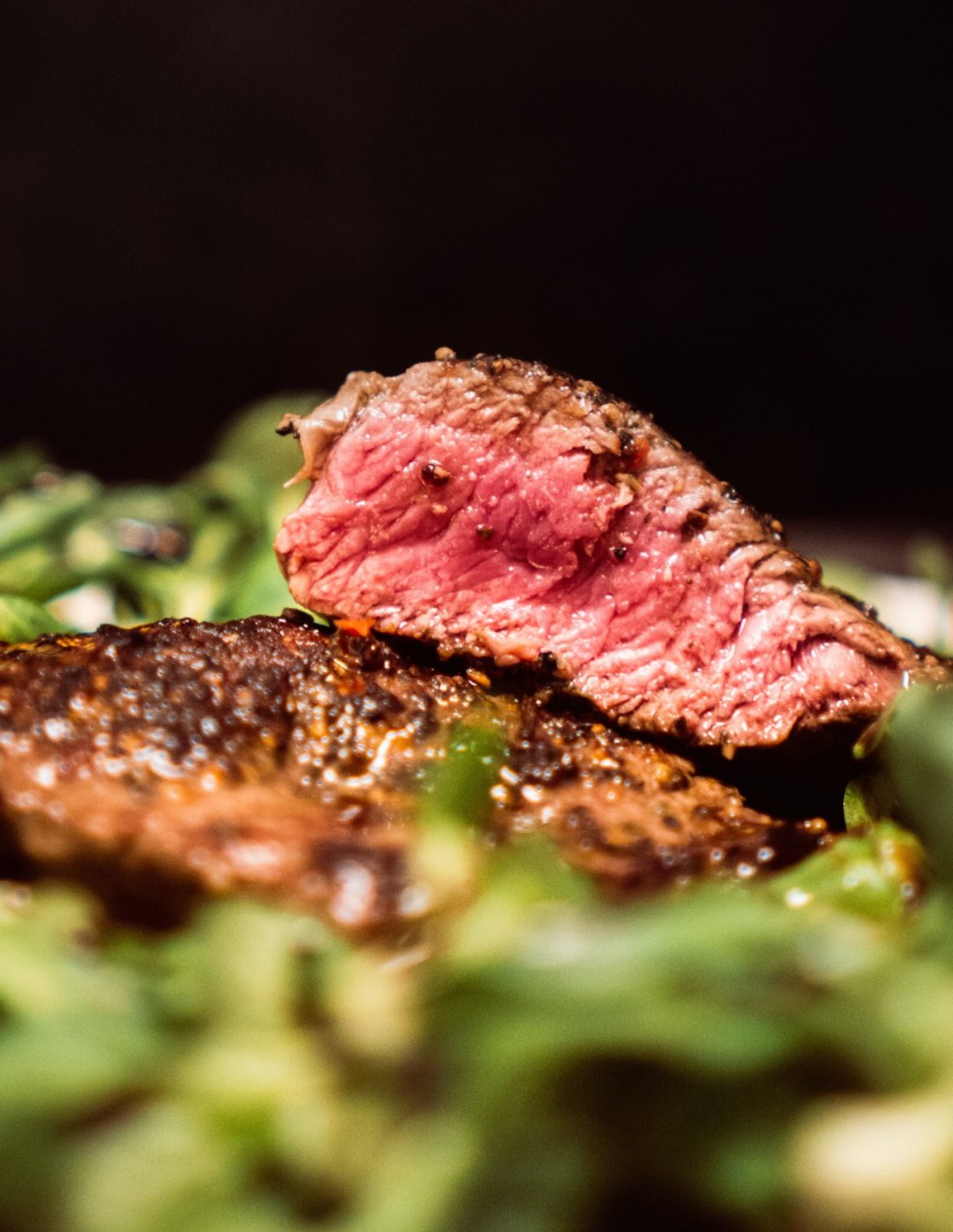 Close-up image of medium rare steak used for display as feature image on post.